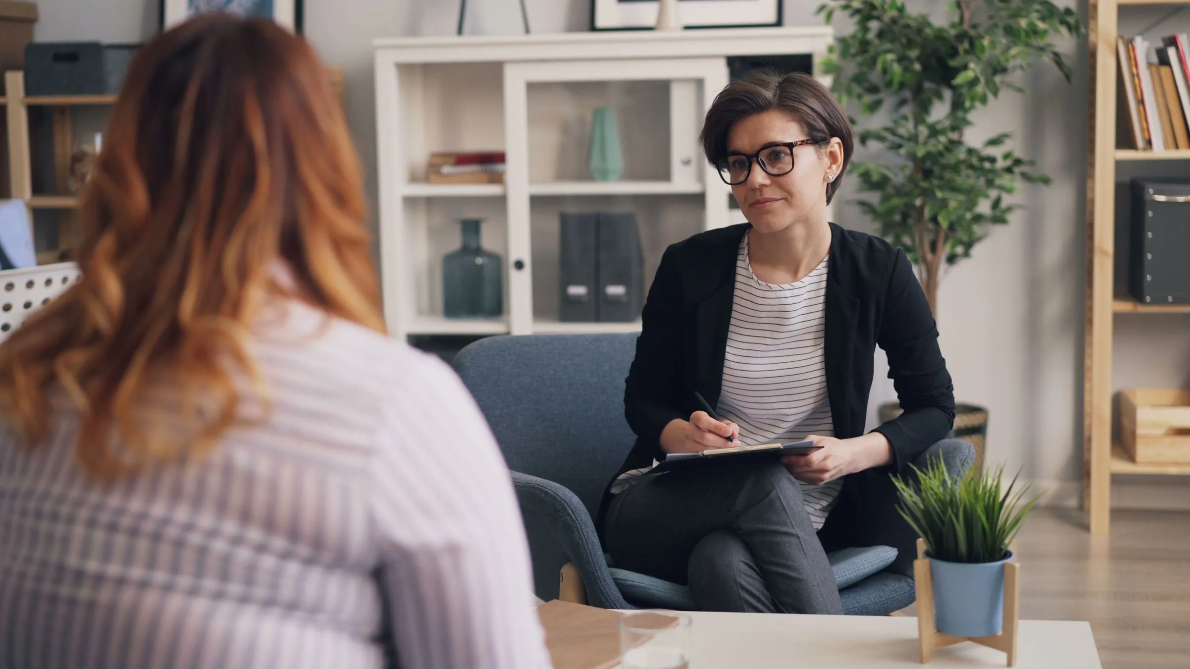 A clinician listening during a consultation in a bright room